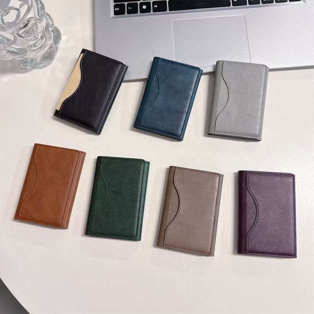 Set of seven small Hand Leather Magnetic iPhone Wallets  in various colors on a light surface.