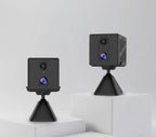 Two black CB70W security cameras on stands against a white background