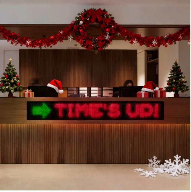 LED Digital Bluetooth Sign displaying  'TIME'S UP!' on a  office reception area with Christmas decorations.