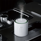 white j03 Car air freshener with steam emitting from it, placed in a car's cup holder.