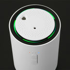 front side picture white J03 Car air freshener. with green lighting on a black background