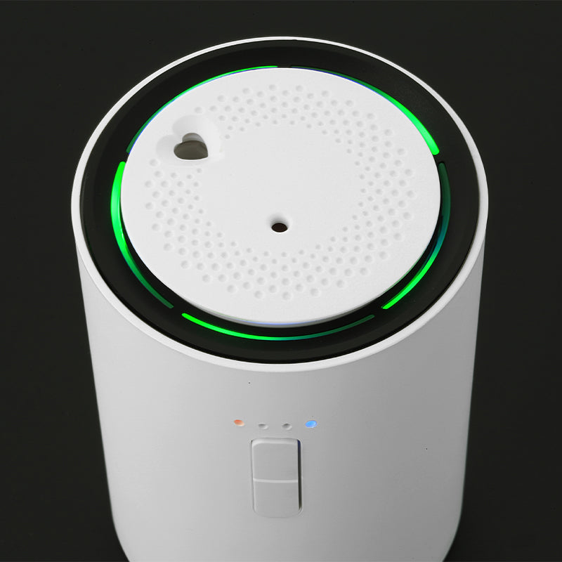 front side picture white J03 Car air freshener. with green lighting on a black background